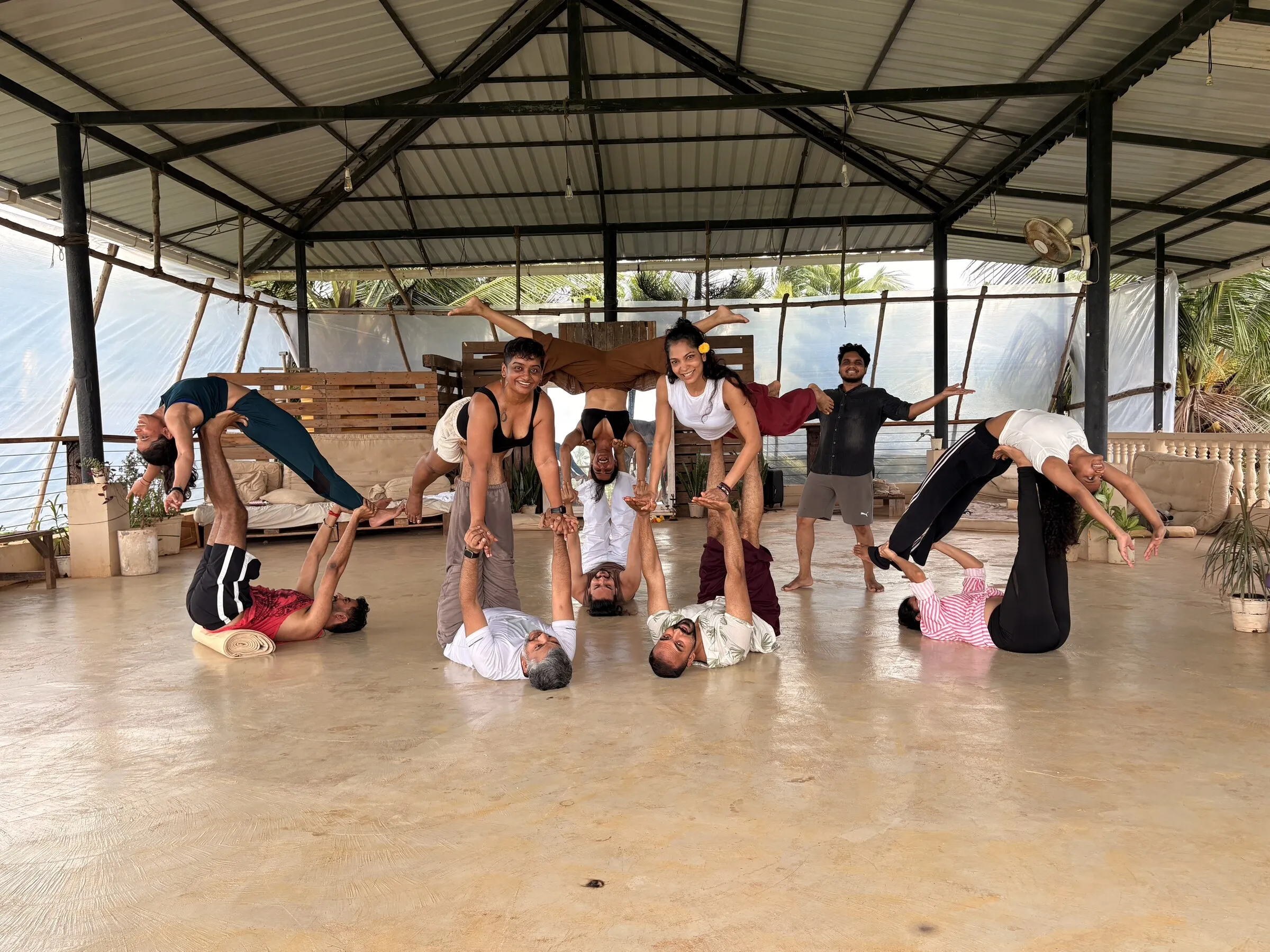 A Shared Gravity group creating a playful arrangement of supported backbends and balances.