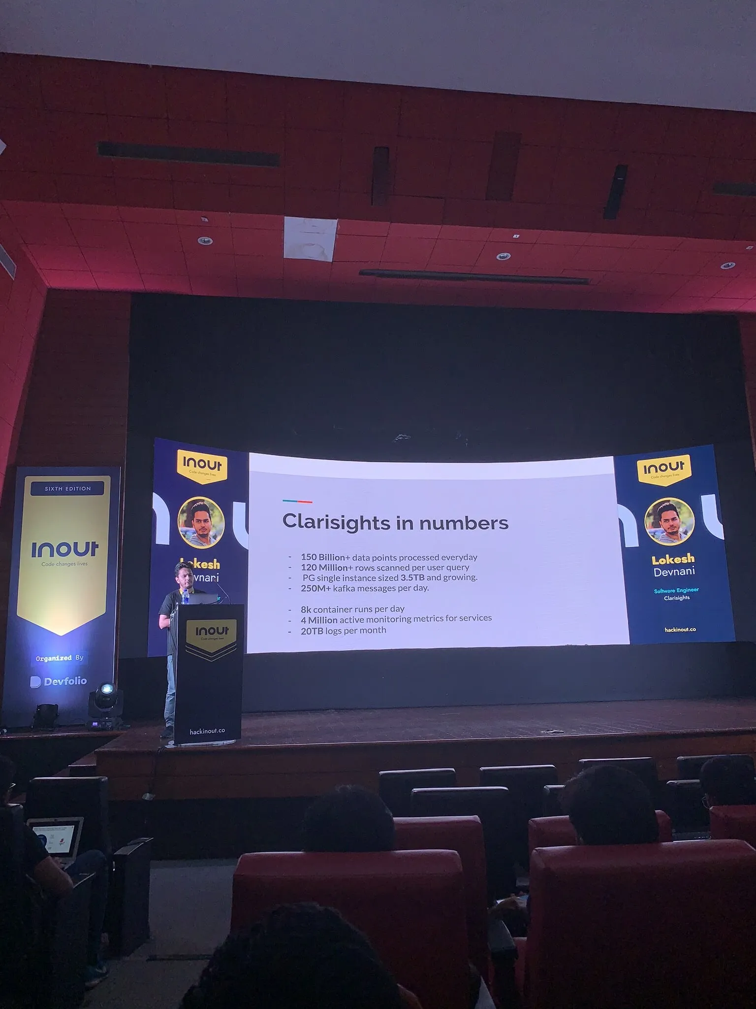Lokesh presenting engineering scale and infrastructure numbers on stage at InOut.